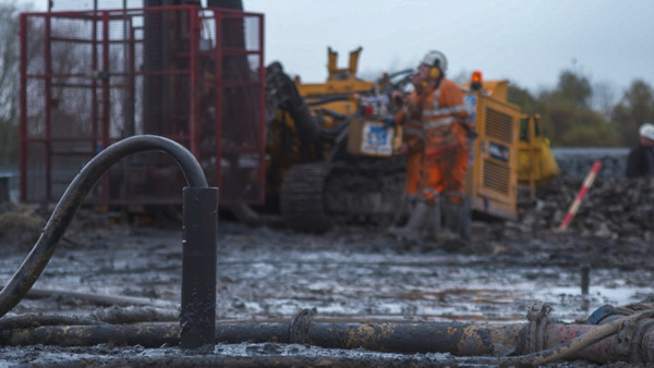 Rotary drill rig with water/air flush system